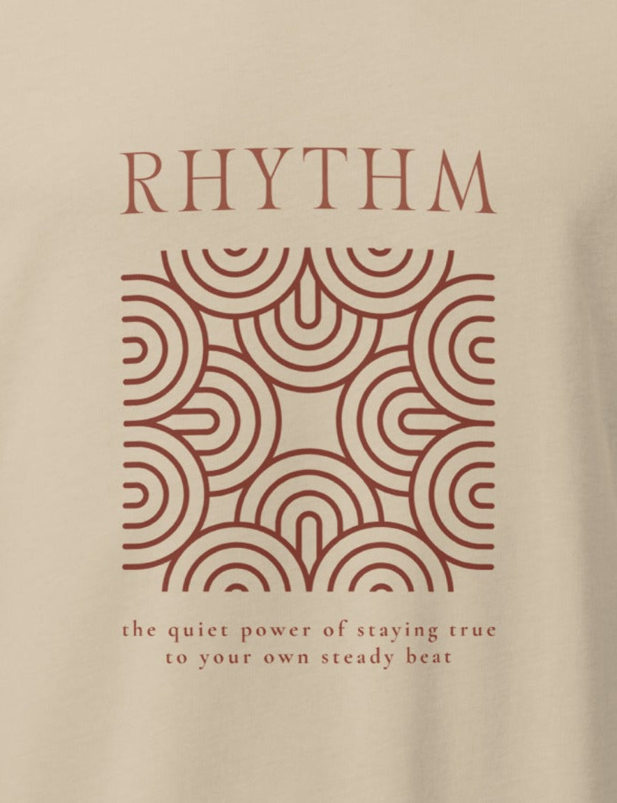 Beige t-shirt with a brown graphic and text on a white background